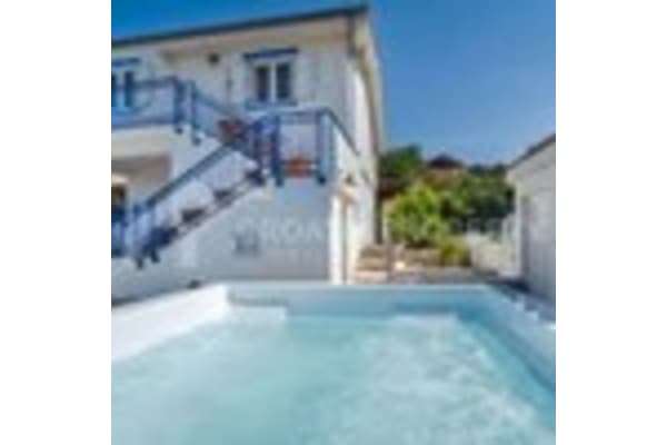 a large swimming pool in front of a house
