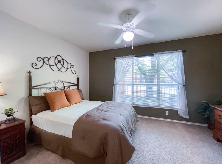 Spacious bedroom with large window at Gates de Provence Apartments in North Dallas, TX