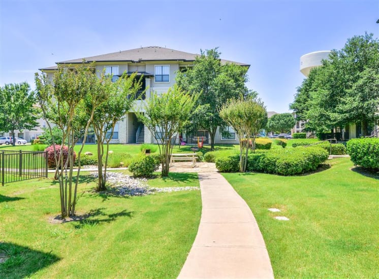 Lush landscaping of Cypress Lake at Stonebriar Apartments in Frisco, TX, For Rent. Now leasing 1, 2 and 3 bedroom apartments.