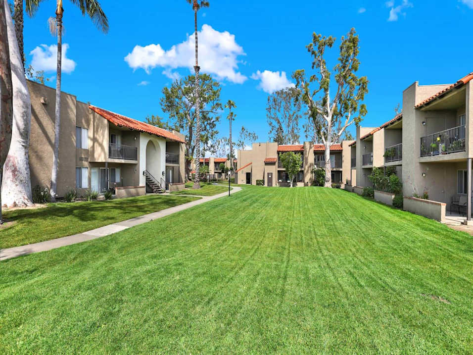 A sunny day at the apartment complex with well-maintained green lawns.
