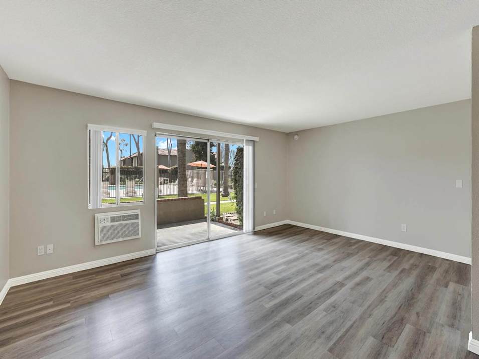 A room with a wooden floor and a wall-mounted display.