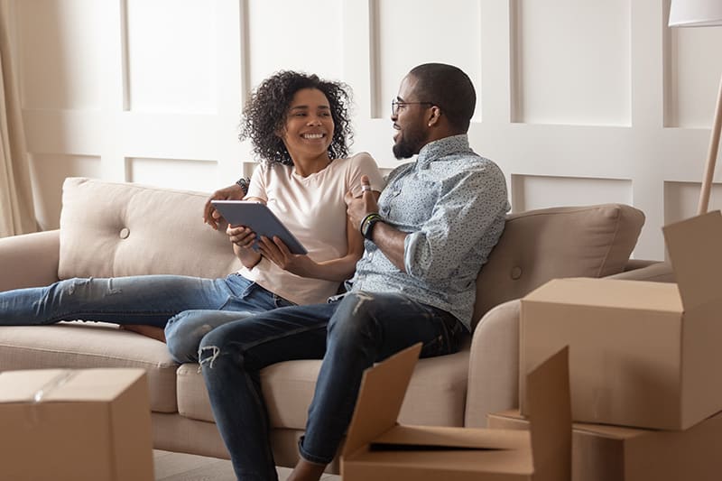 A diverse couple happy on a sofa