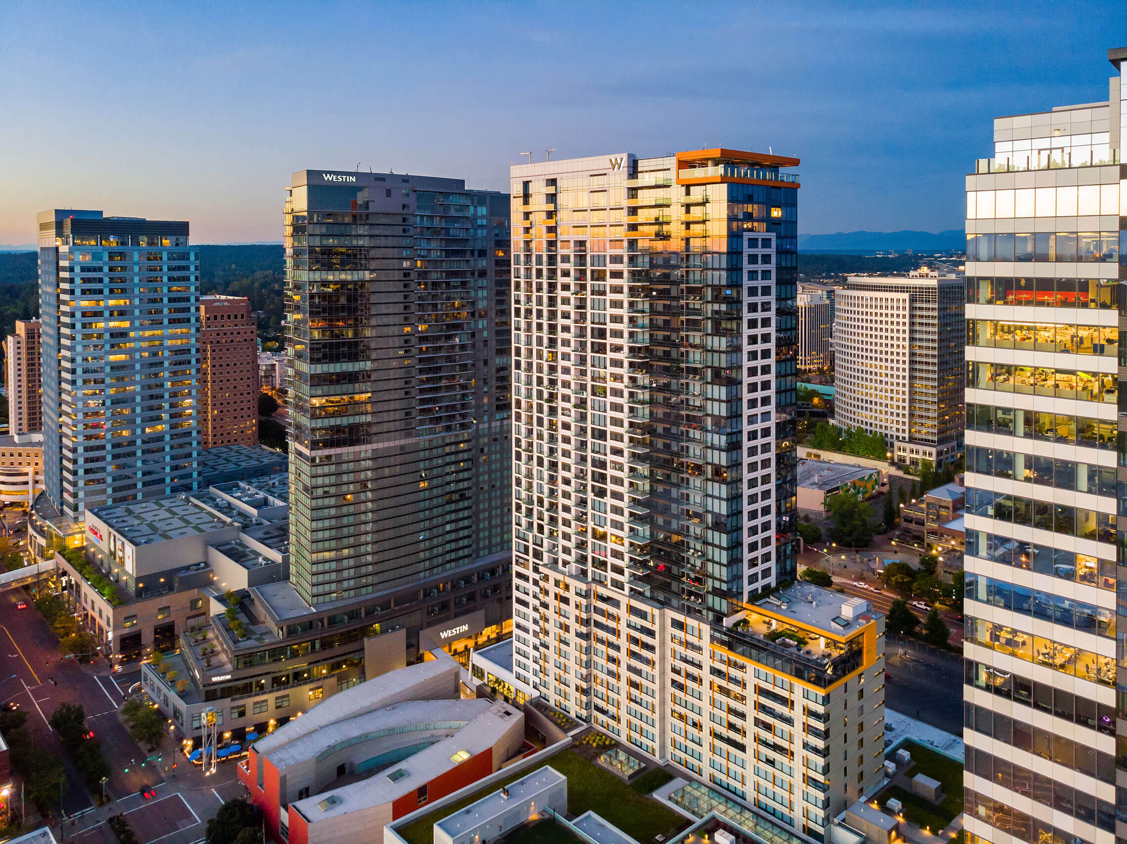 a city skyline with tall buildings at sunset at Two Lincoln Tower, Bellevue, WA, 98004