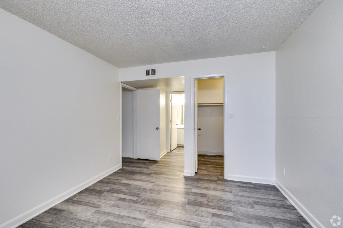 Unfurnished bedroom with closet and bathroom access at Sagewood Apartments