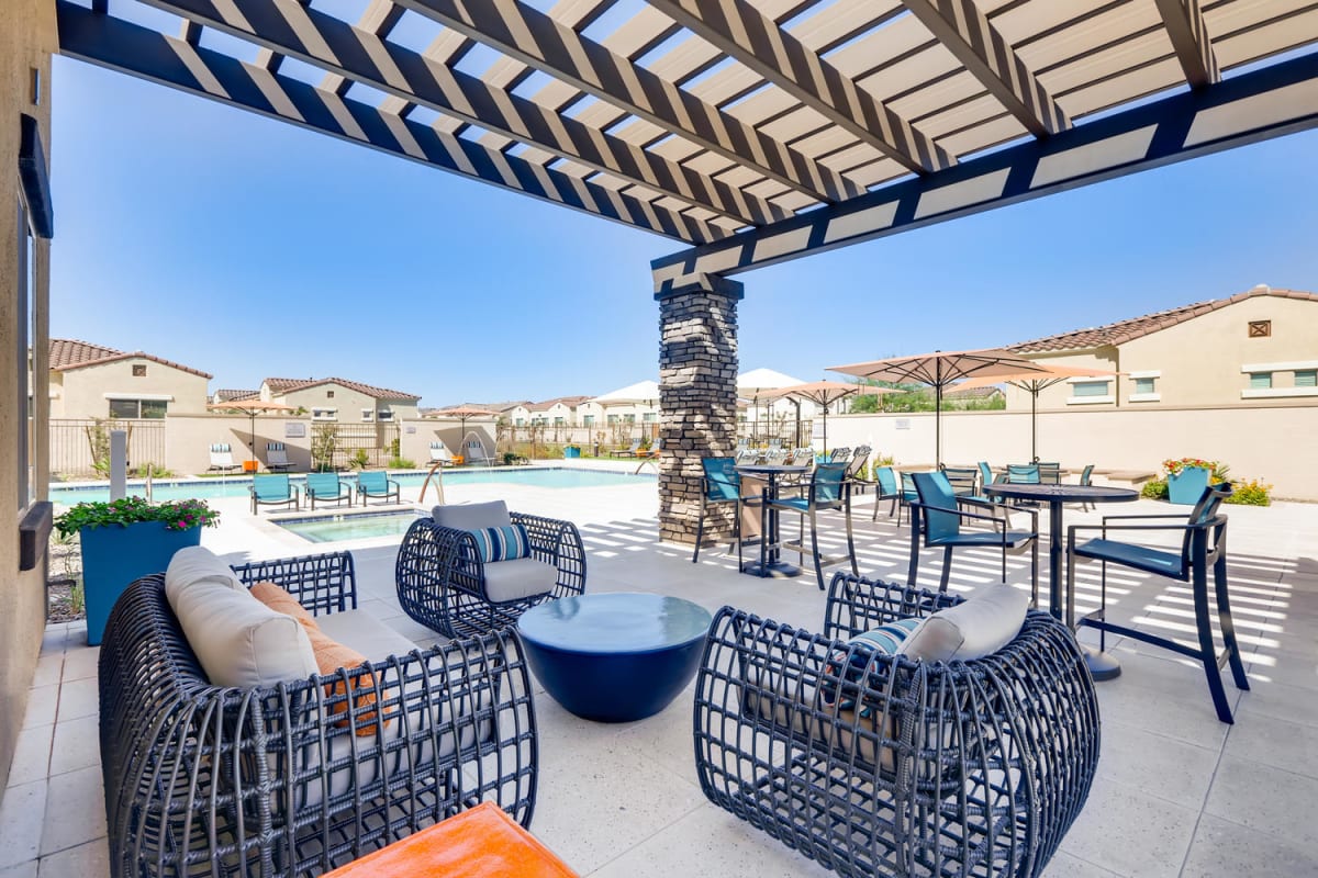 Covered lounge seating beside the pool.