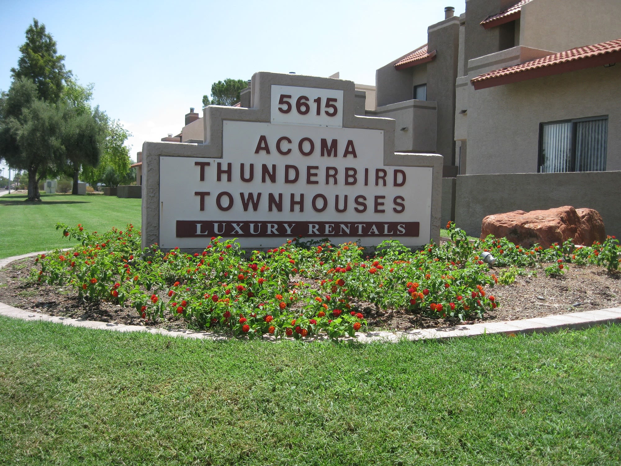 Entrance sign and townhomes at Acoma Thunderbird Townhomes