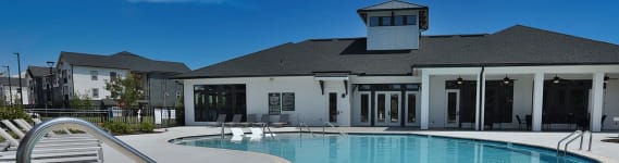 a large swimming pool with a building in the background