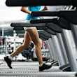 A gym with treadmills, exercise bikes, and weight machines.