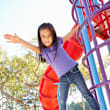 A playground with a blue slide and wooden structure.