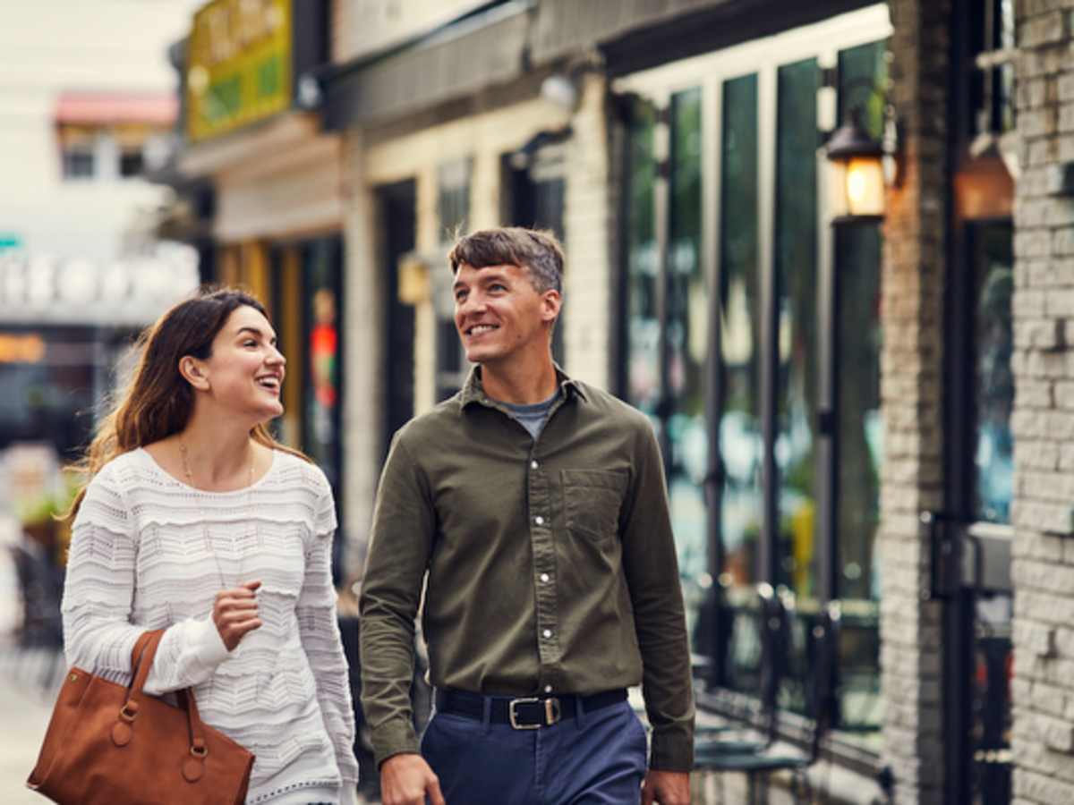 Couple walking past storefronts in downtown Bethesda
