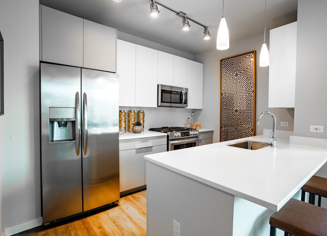 Unit Kitchen with Stainless Steel Appliances and Quartz Countertops at The Grand Central Apartments in Chicago, IL 60607
