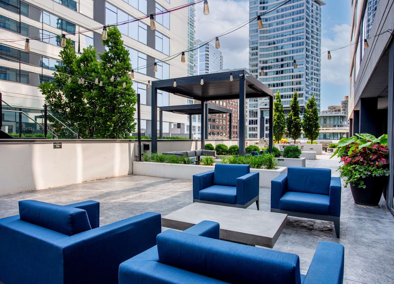 Outdoor Patio Space with Seating and Grill at The Grand Central Apartments in Chicago, IL 60607