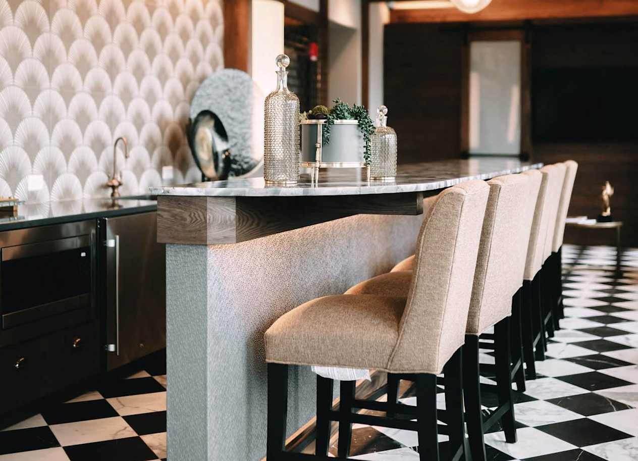 a long bar with chairs with a checkered floor at The Grand Central, Chicago, IL