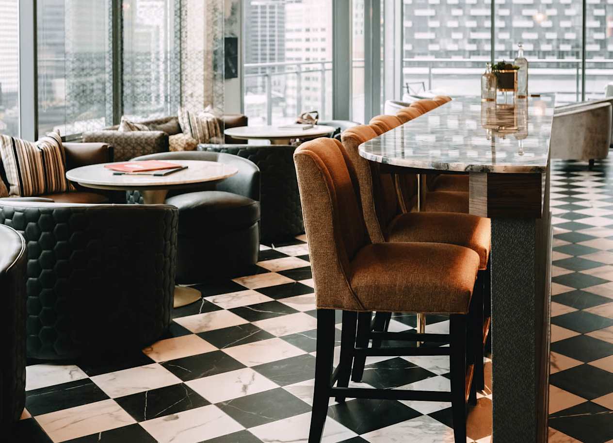 a lounge with a checkered floor and tables and chairs at The Grand Central, Illinois, 60607
