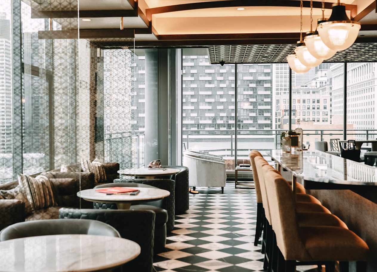 a black and white checkered floor with tables and chairs at The Grand Central, Chicago, IL