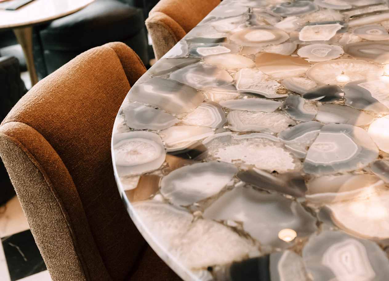 a long marble table with chairs at The Grand Central, Chicago, IL 60607