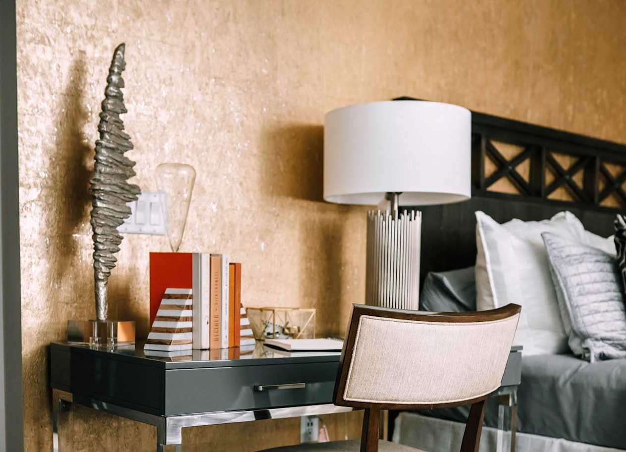 a desk with a lamp and a chair in a bedroom at The Grand Central, Illinois