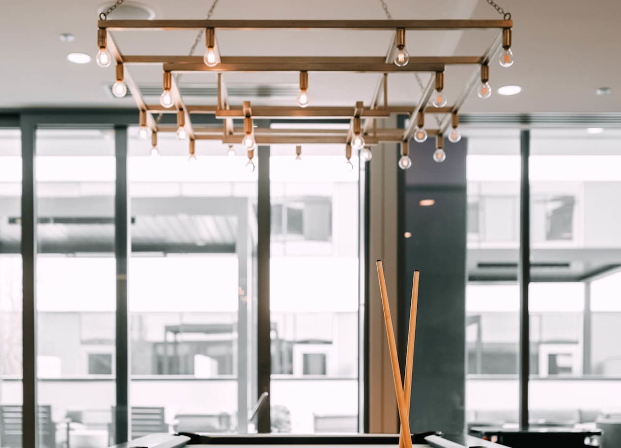 a pool table in a room with glass windows at The Grand Central, Chicago Illinois