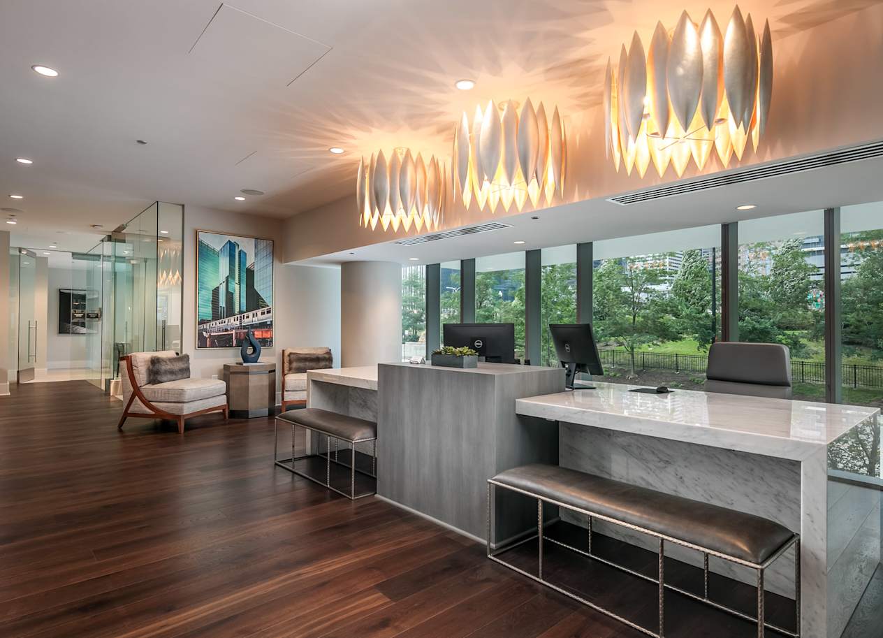 the lobby of a hotel with a reception desk and large windows at The Grand Central, Chicago Illinois
