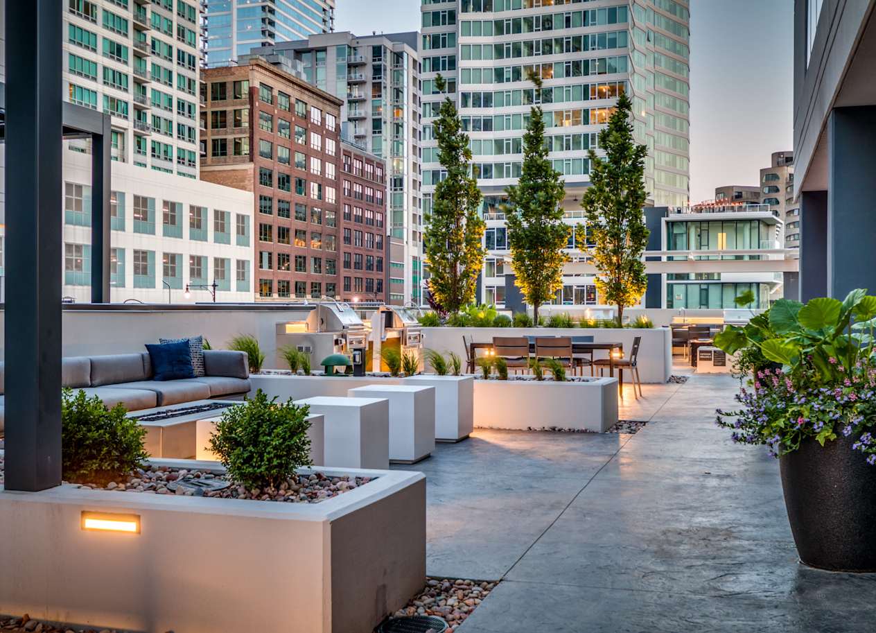 a terrace with couches and a table with plants at The Grand Central, Chicago, IL 60607