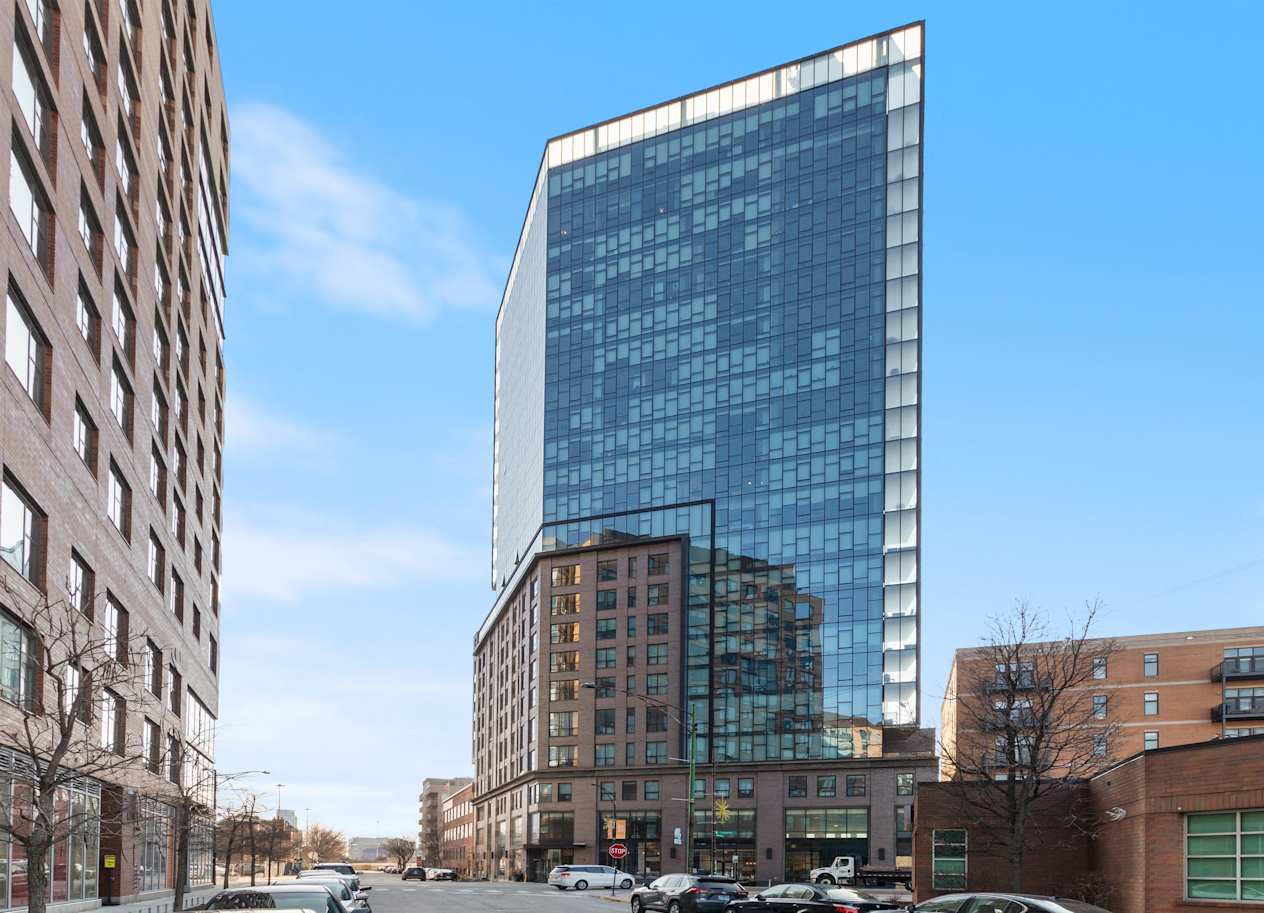 a tall glass building on a city street