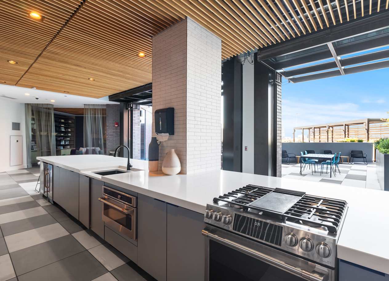 a kitchen with an island and a stove and a patio