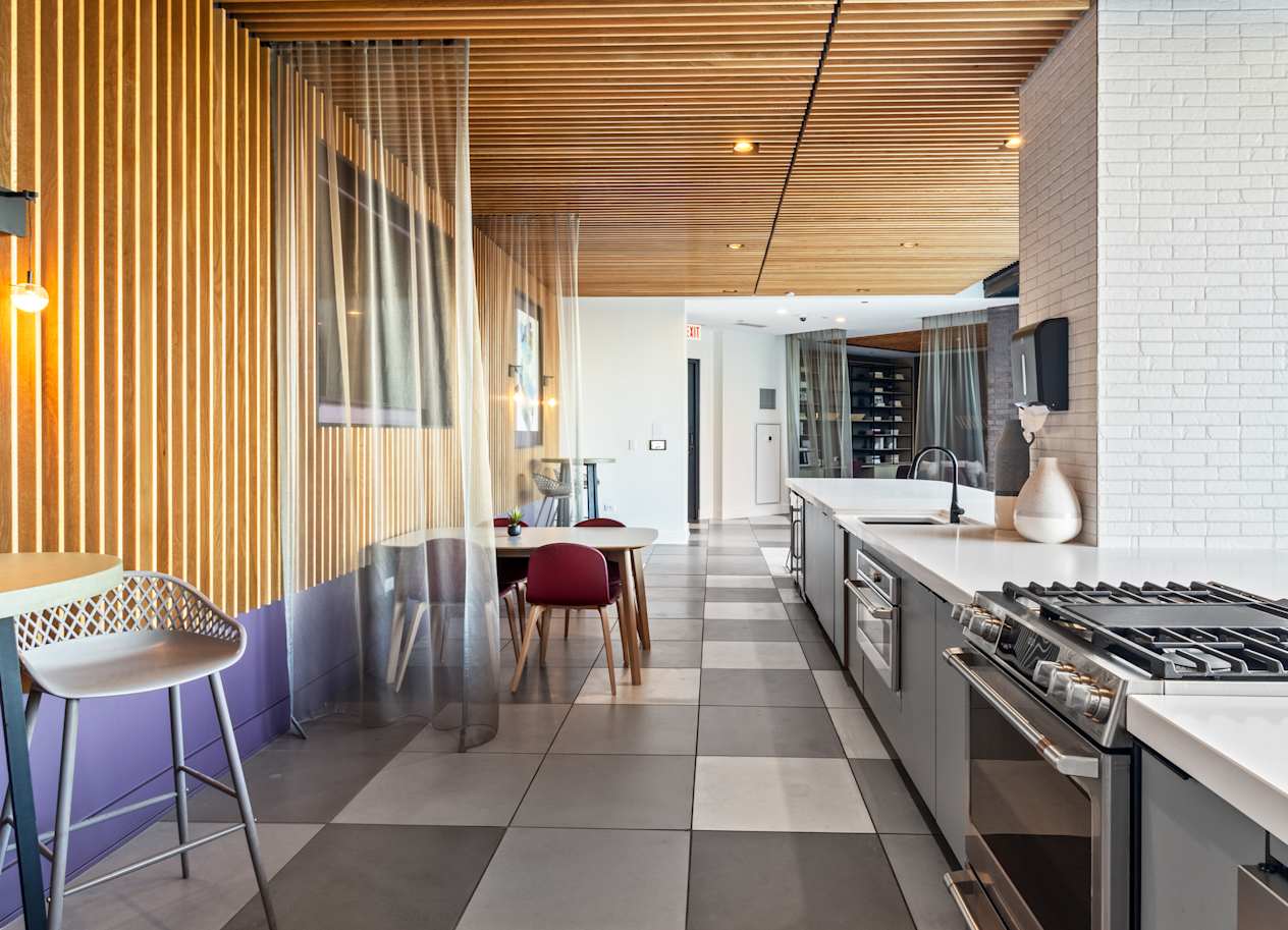 a kitchen with a stove and a table with chairs