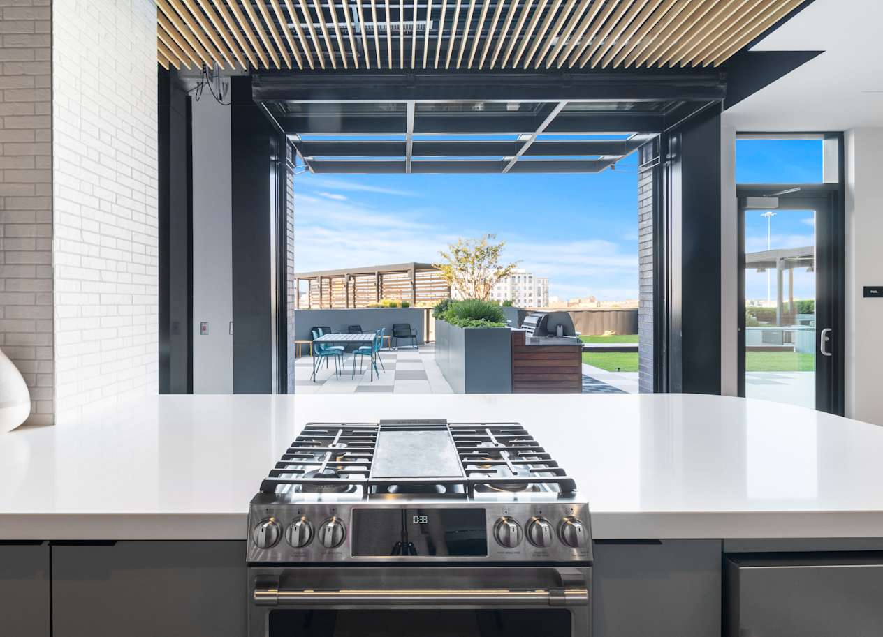 a kitchen with a stove and a view of a patio