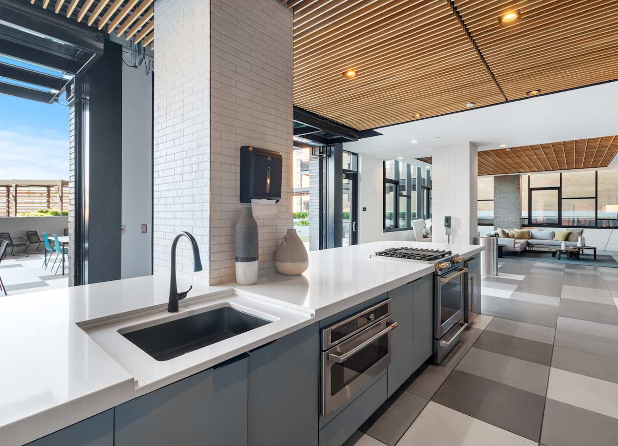 a kitchen with white countertops and a sink in a house