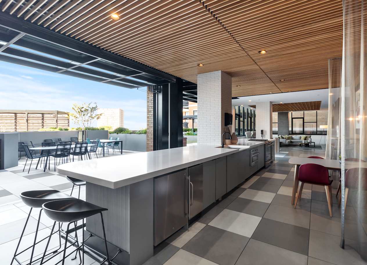 a communal kitchen and dining area with tables and chairs