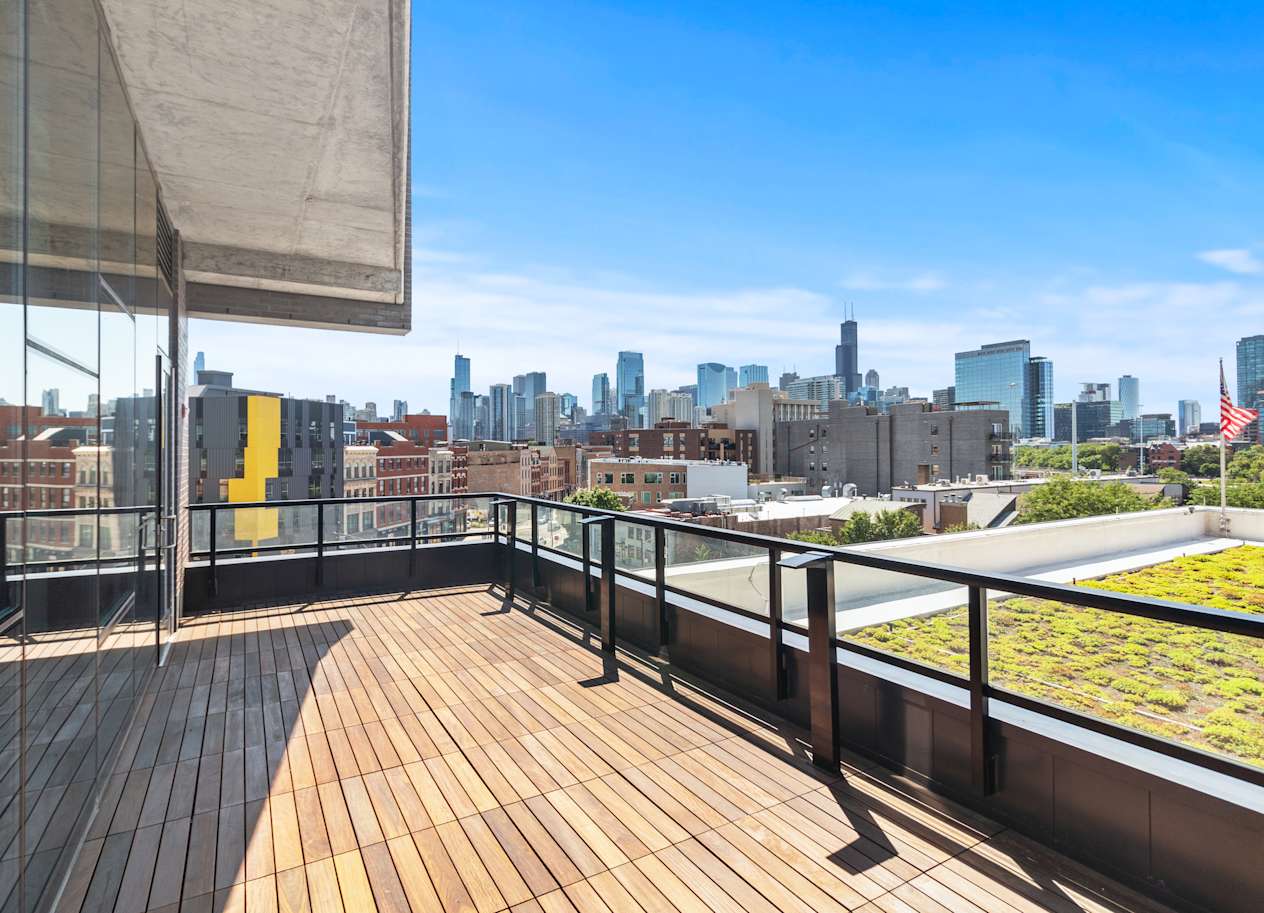 the view of the skyline from the rooftop deck of a building with wood