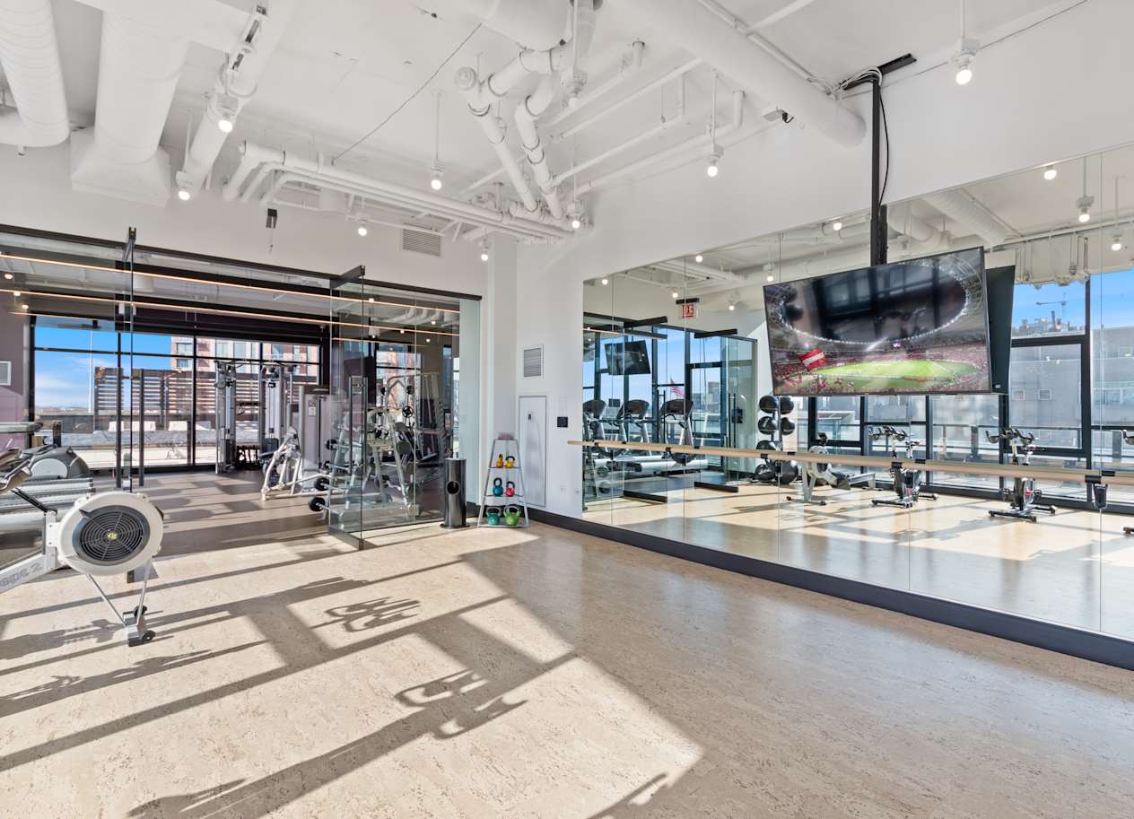 a view of the floor of a brewery with beer machines and a large window