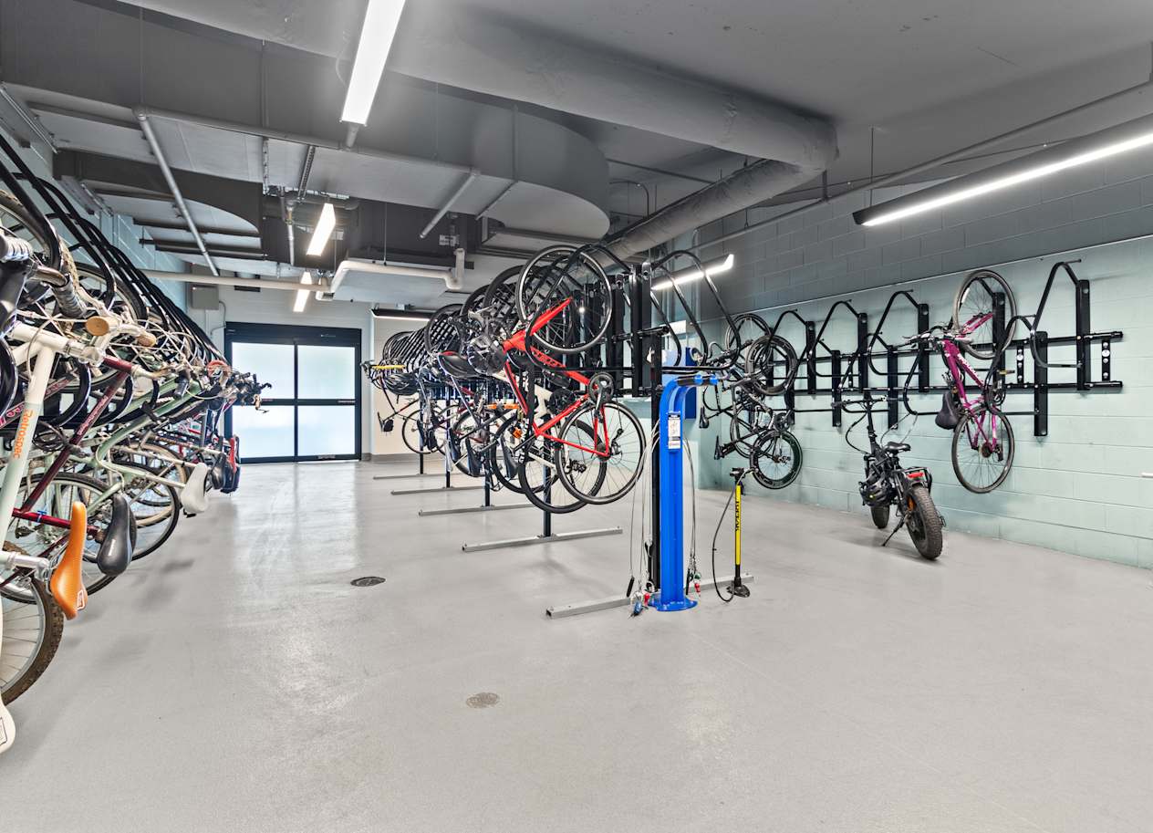 a large room filled with bikes and bikes hanging on a wall