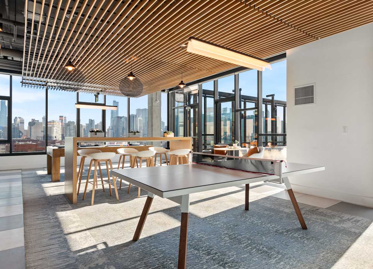 a ping pong table in a room with a view of the city