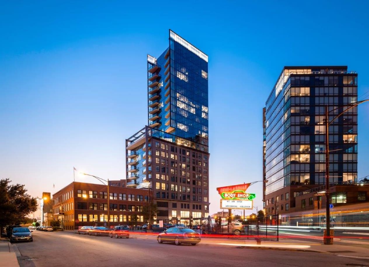 a city street with two tall buildings in the background