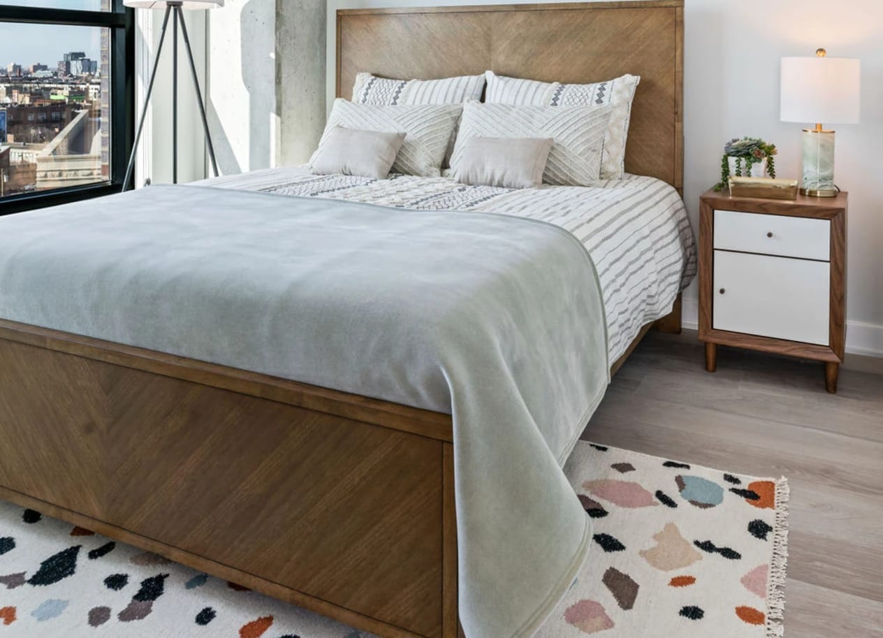 a bedroom with a large bed and a large window