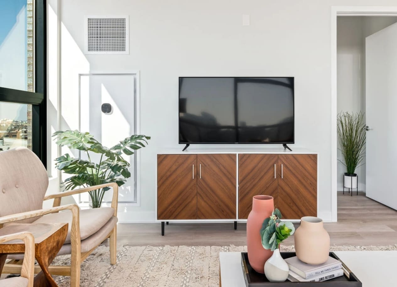 a living room with a tv on the wall