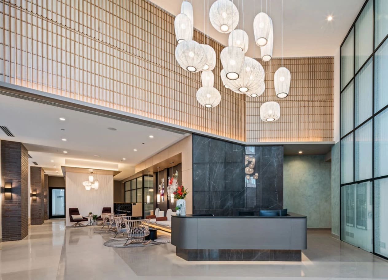 a large lobby with a large chandelier hanging from the ceiling