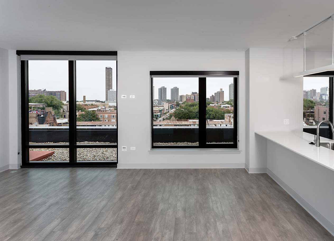 a kitchen with a large window and a white counter top at Residences at Addison Clark Apartments, Chicago, IL