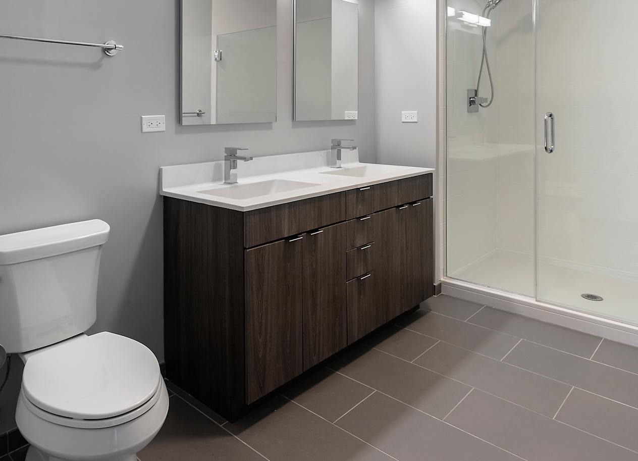bathroom with toilet sink and shower at Residences at Addison Clark Apartments, Chicago, IL, 60613