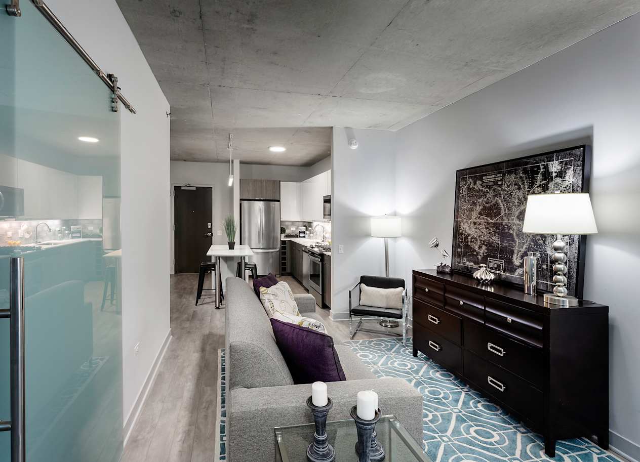 a living room and kitchen in a studio apartment at Residences at Addison Clark Apartments, Chicago, IL, 60613
