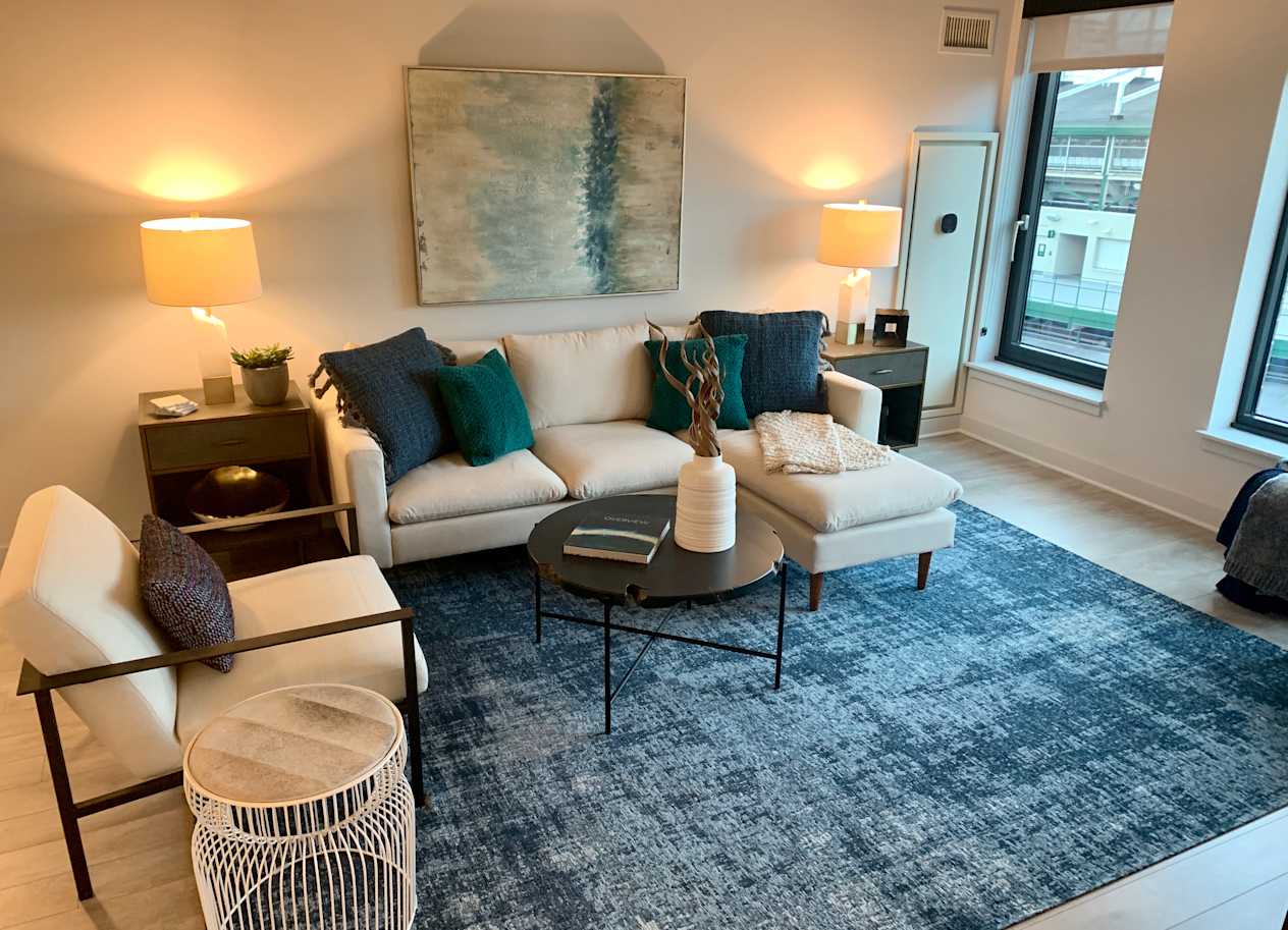 a living room with a couch and a rug at Residences at Addison Clark Apartments, Chicago, 60613