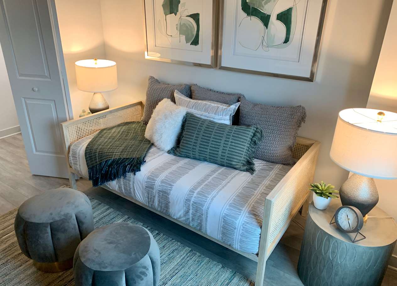 a bedroom with a bed with pillows and lamps at Residences at Addison Clark Apartments, Chicago, IL