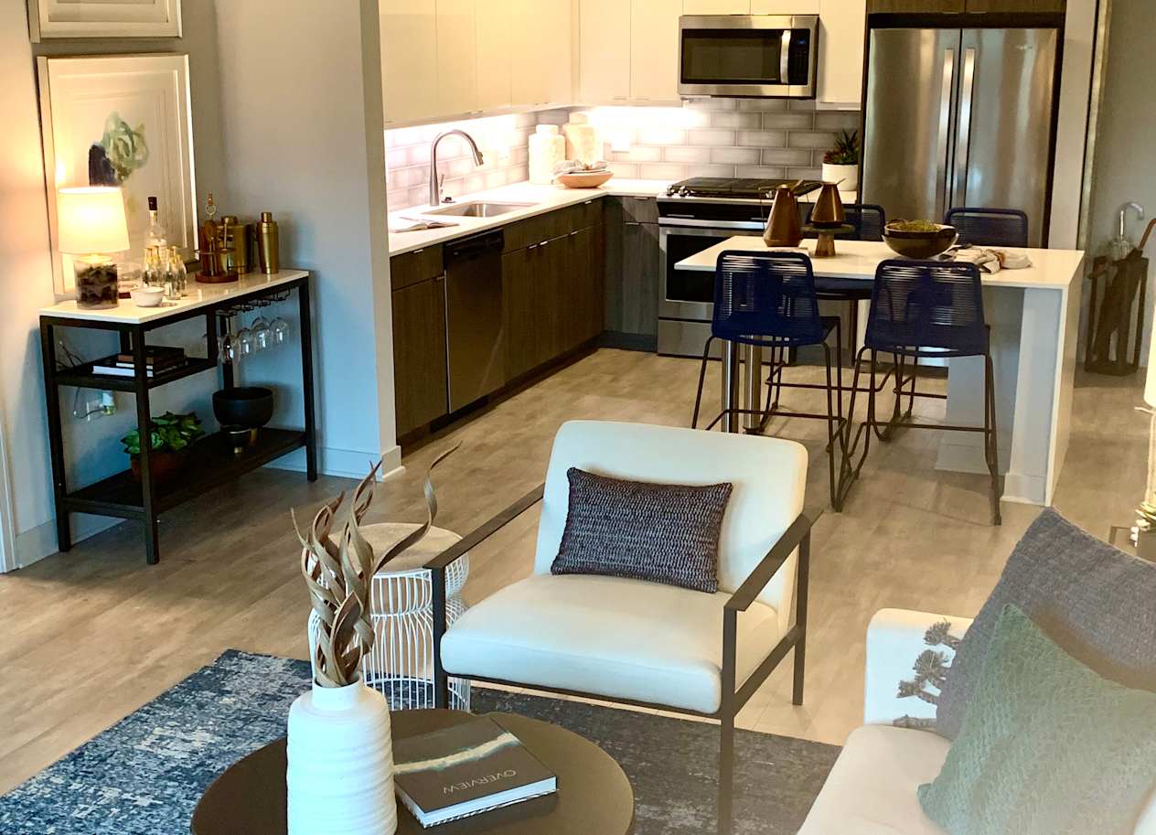 a living room and kitchen with a couch and a table  at Residences at Addison Clark Apartments, Chicago, 60613