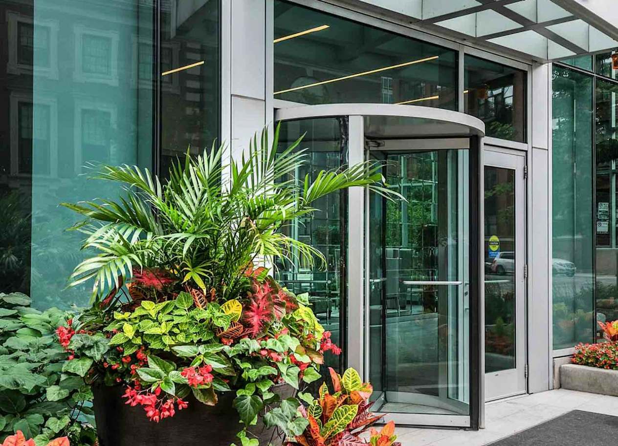 a glass revolving door in front of a building
