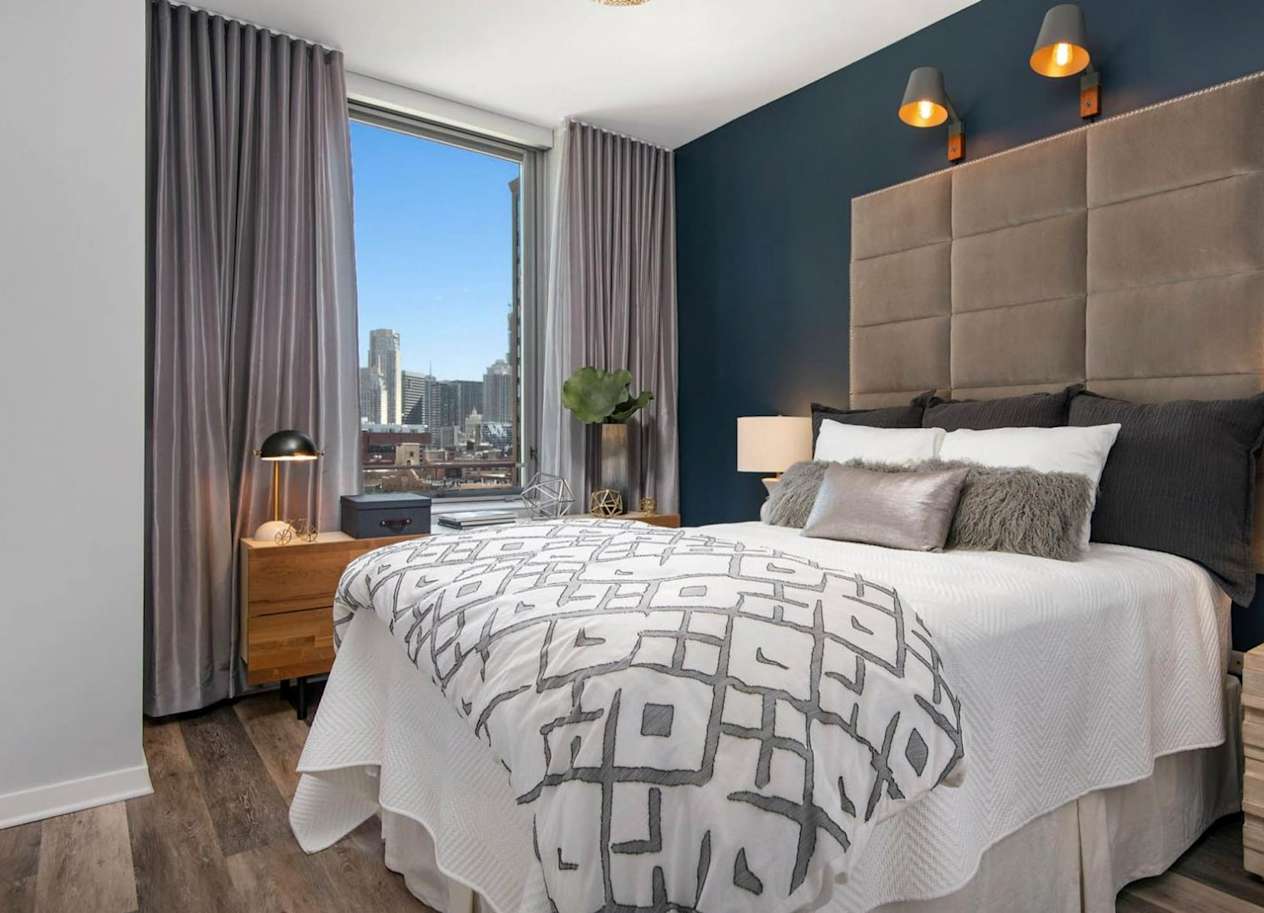 a bedroom with a large bed and a window