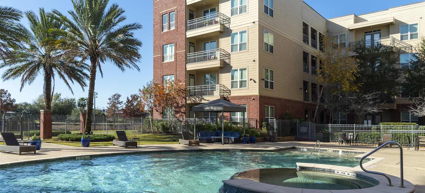 The pool in front of a multi-storey apartment building