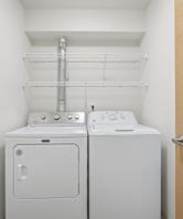 A white washing machine and dryer in a small laundry room.