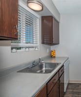 a kitchen with wooden cabinets and white appliances at Lincoln Village Apartments, Washington