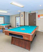 a games room with two pool tables and a foosball table at Lincoln Village Apartments, Washington